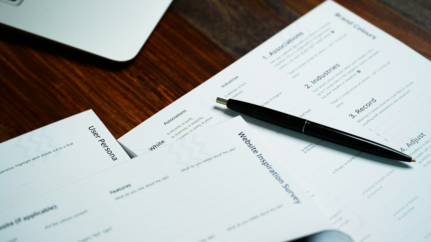 Pen resting on a pile of tax and loan documents