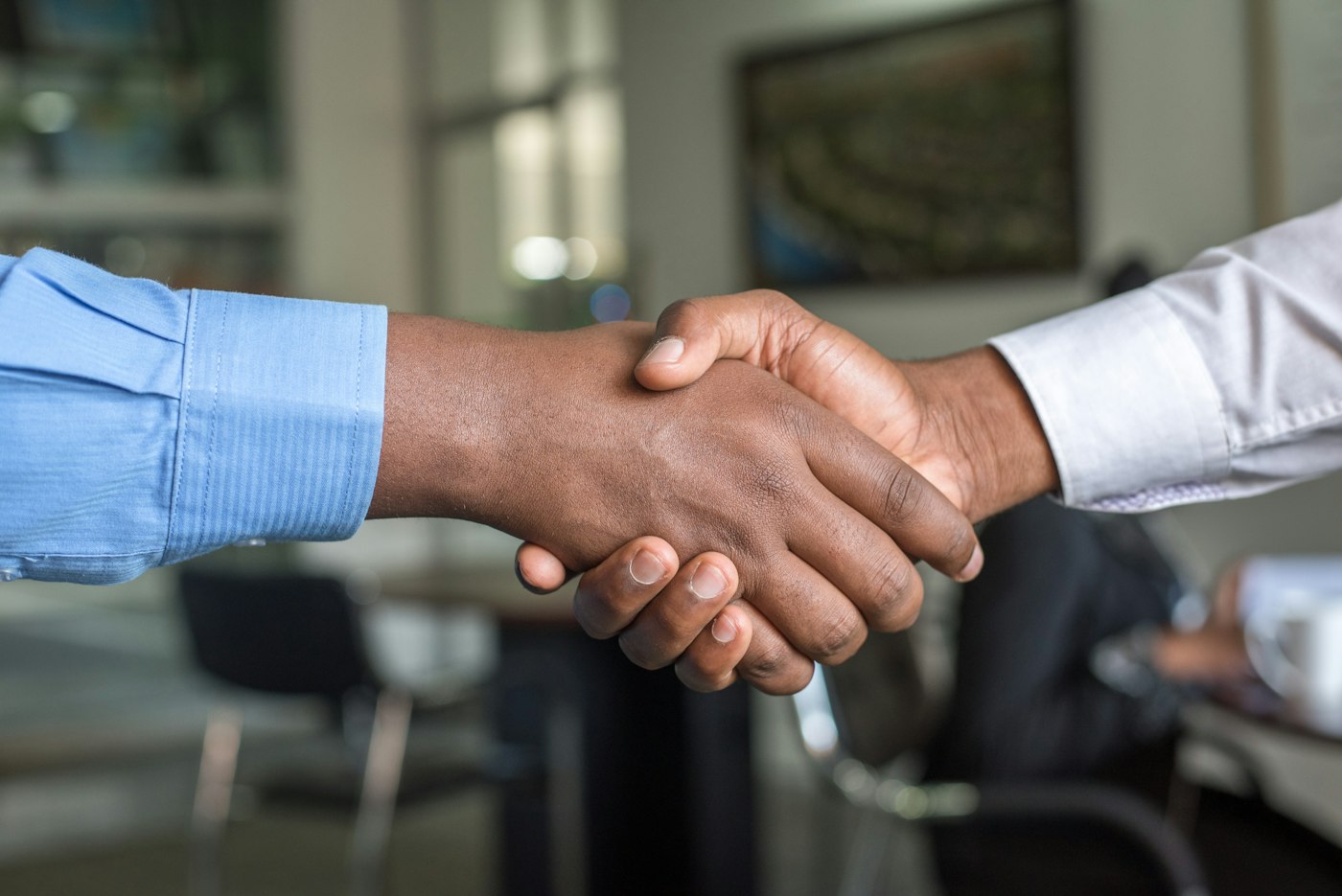 Two people shaking hands after a loan review
