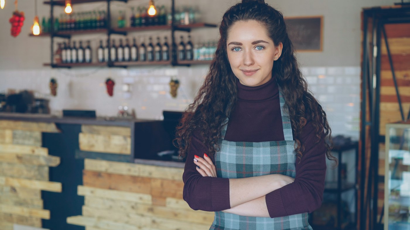 Small business owner standing in her coffee shop