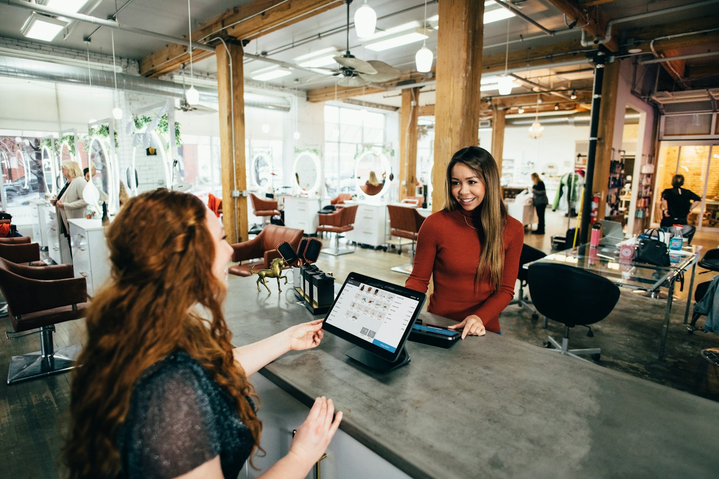 Small business owners serving customers in a retail store